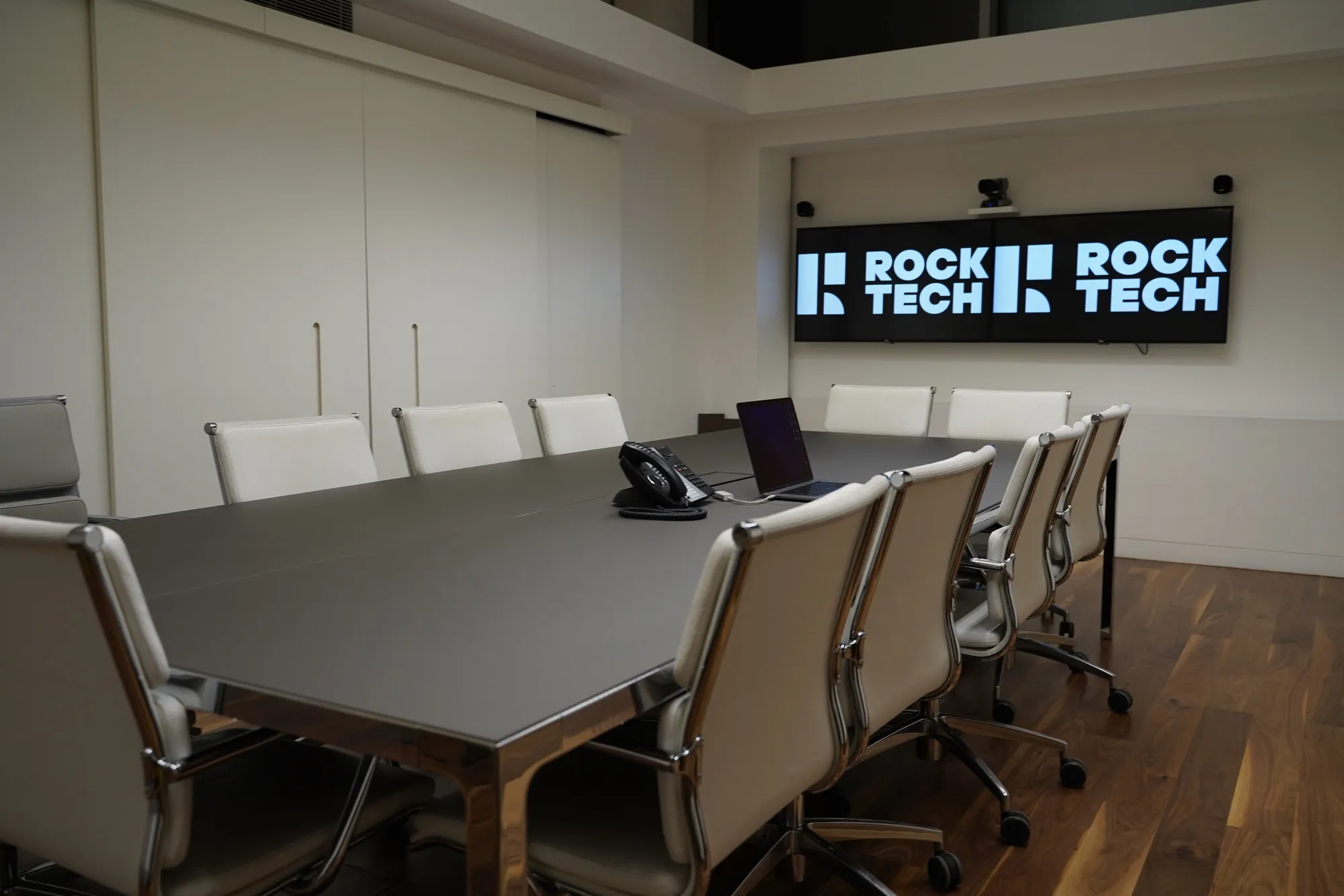 Wide view of the conference room and installed display systems